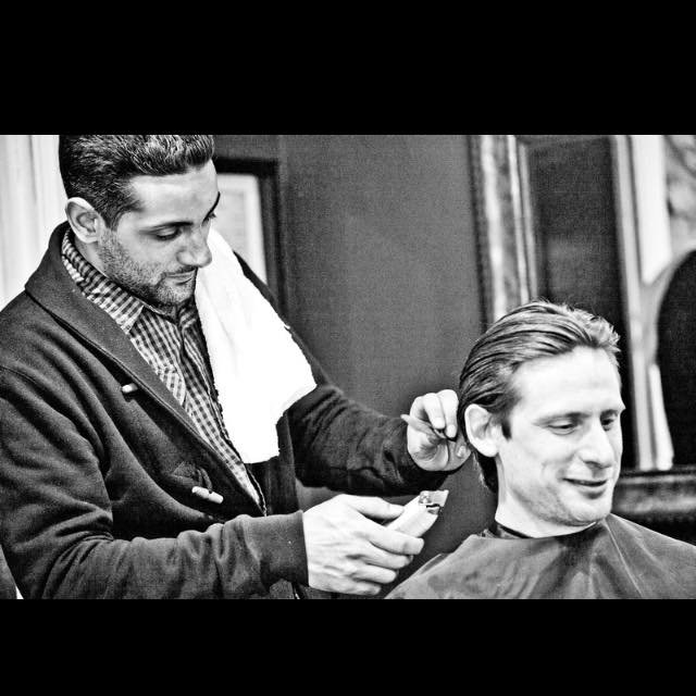 Leo cutting a client's hair
